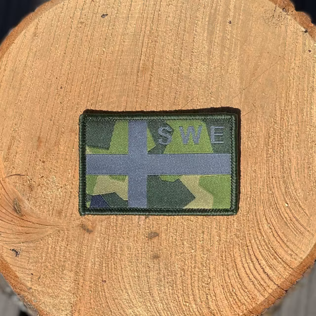 Sweden Flag OPS M90 Patch from TAC-UP GEAR on a piece of wood