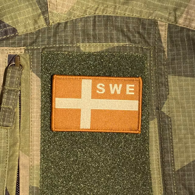 Sweden Flag OPS Sand Patch monted on a M90 camouflage shirt sleeve