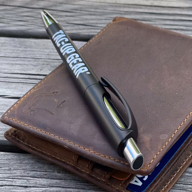 A Pen EDC Black from TAC-UP GEAR lying an a leather wallet
