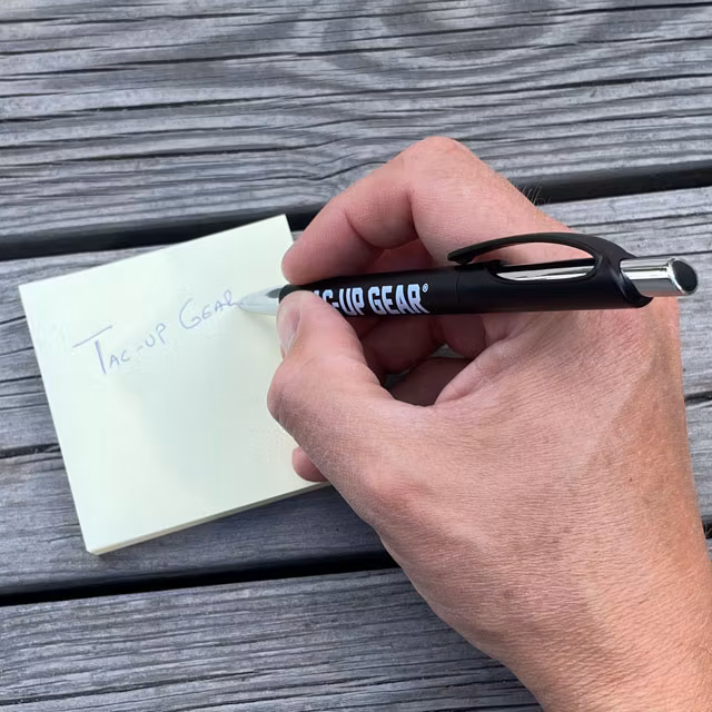 Blue ink on a yellow Post it from the Pen EDC Black from TAC-UP GEAR