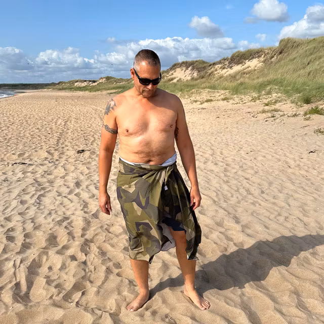 Sarong M90 Camouflage from TAC-UP GEAR is wrapped around the body on the beach