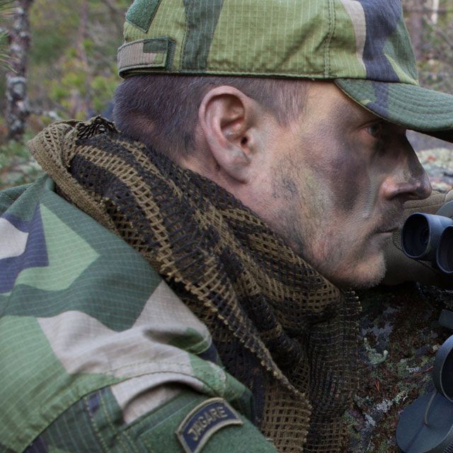 A Scrim Scarf Black/OD Camo worn together with green face camo and M90 uniform.