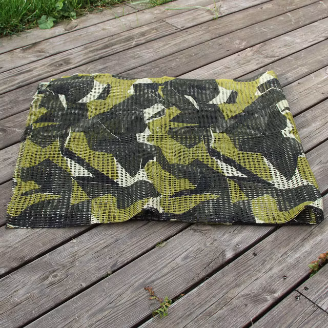 A Scrim Scarf M90 against a woody background.