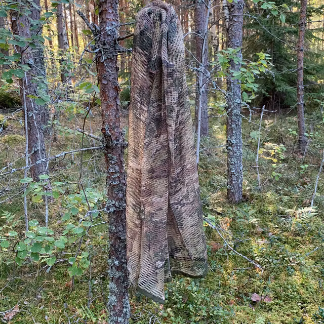 Scrim Net Scarf Multicam hanging on a tree in the Swedish forest