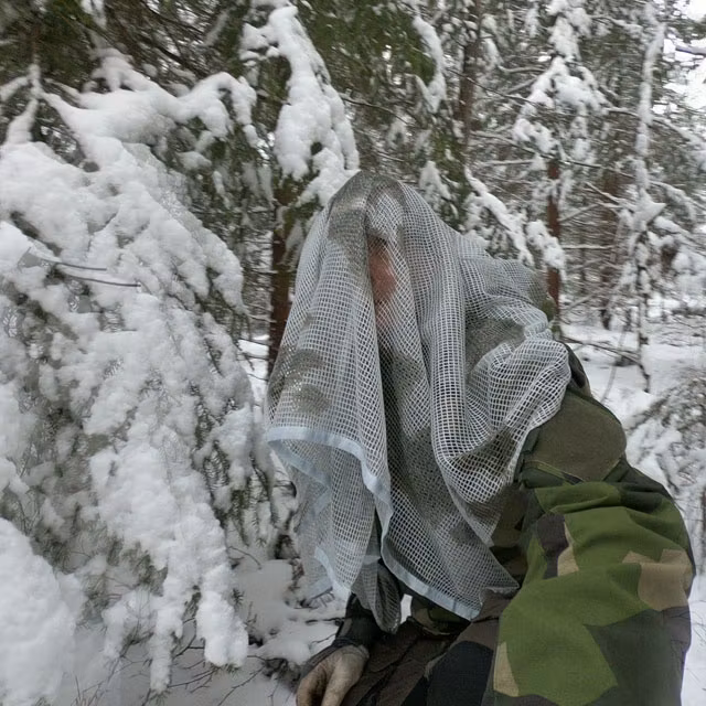 Scrim Net Scarf White Moss draped over man in M90 in Swedish winter forest