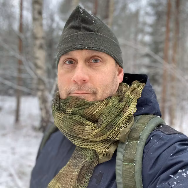 a Scrim Net Scarf Woodland worn in snowy weather