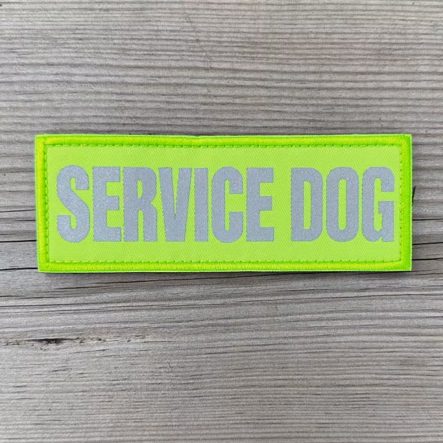 Service Dog HiVis PVC Patch displayed on a wooden surface