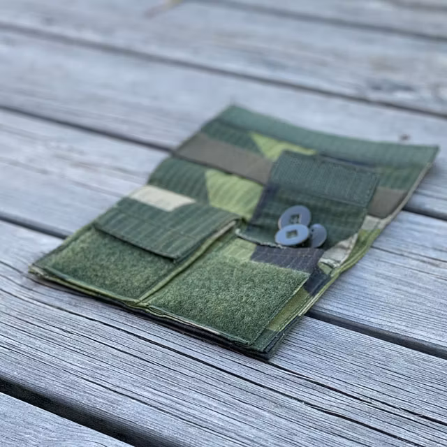 Sewing Case M90 from TAC-UP GEAR seen open from an angle lying flat on wooded floor