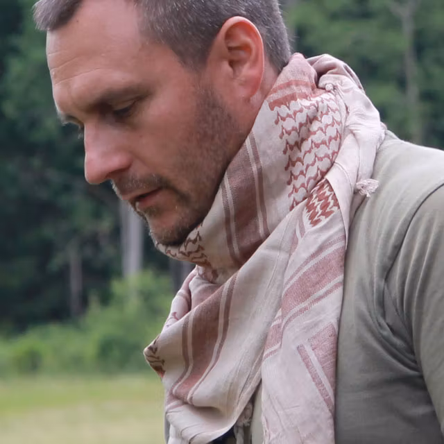 Shemagh Light Khaki/Brown worn and Swedish woods in the background.