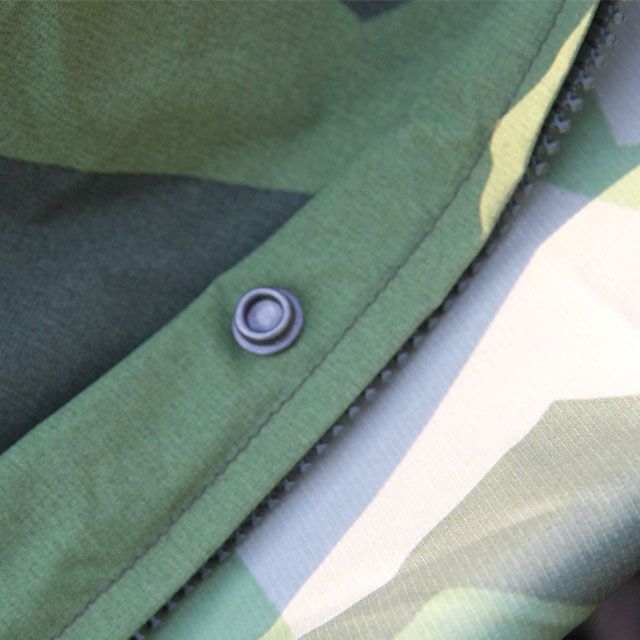 Close up of zipper and eyelet on a Tarp Poncho M90.