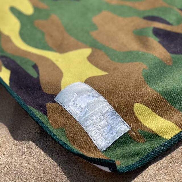 A closer look at a Towel Camouflage from TAC-UP GEAR laying in the sun on the beach