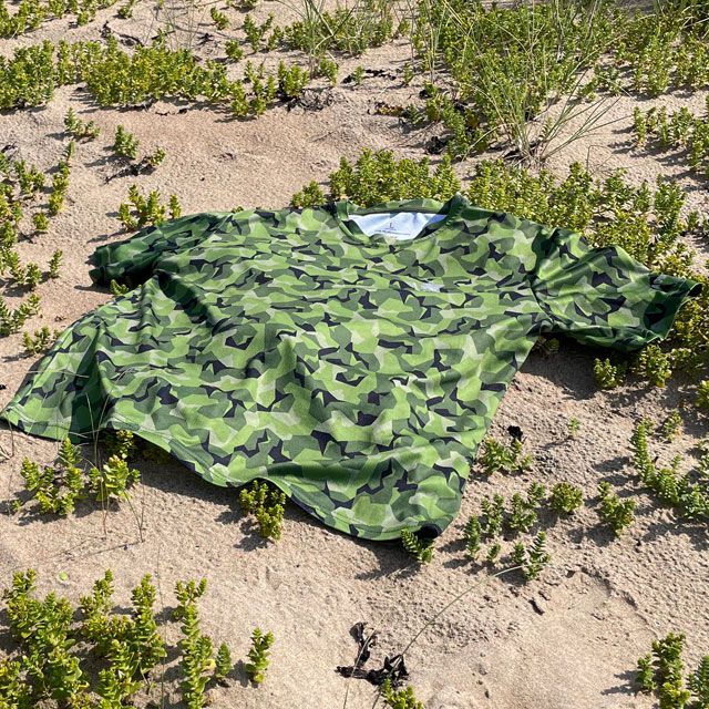 A Training T-Shirt M90 MI lying flat on the beach