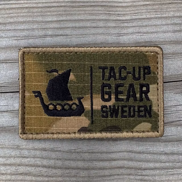 TUG Multicam Hook Patch displayed on a wooden surface