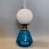 liten turkos antik fotogenlampa