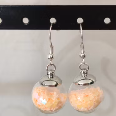 Örhängen glasglob med ljusorange stjärnglitter