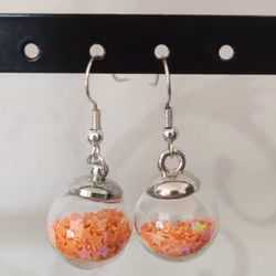Örhängen glasglob med orange stjärnglitter