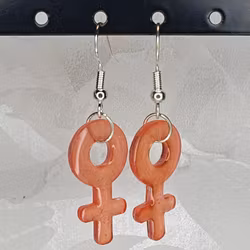 Örhängen med små kvinnosymboler i bright orange