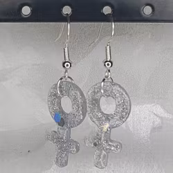 Örhängen med små kvinnosymboler med glitter silver