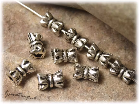 Mellandel i tibetsilver kärve 30-pack ca 6x4 mm