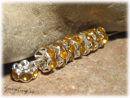 Silvrig rondell med ljus bärn strass ca 7 mm