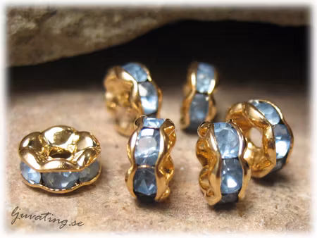 Guldig rondell med blå Rhinestone ca 6 mm