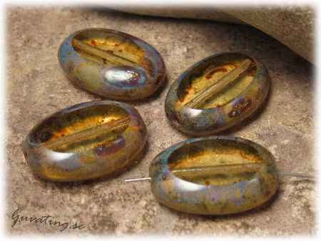 Ljus topaz glaspärla med gråblått ca 18x13 mm