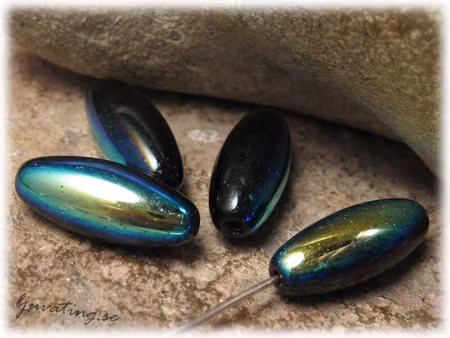 Svart med AB lyster risformad ca 16x7 mm