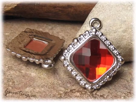 Hänge i metall  med röd fasett ca 32x28 mm