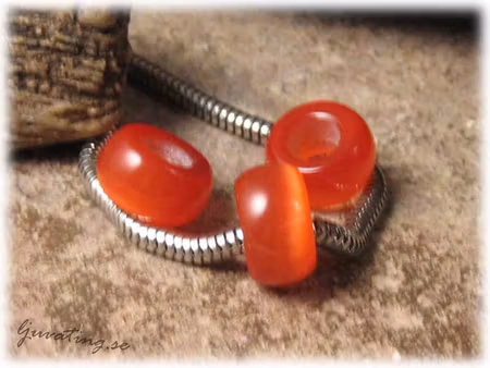 Ormlänkspärla rödorange cat eye ca 14x8mm