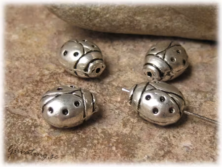 Nyckelpiga i metall ca 11x10 mm