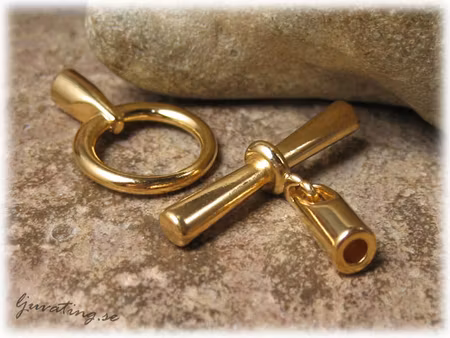 Toggle lås guldfärgad metall hål ca 3 mm