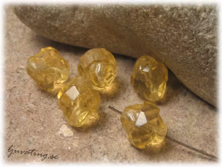 Gul bicone facettslipad på mitten ca 11x10 mm