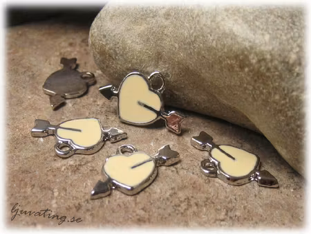 Berlock i metall beige hjärta med pil ca 21x13 mm