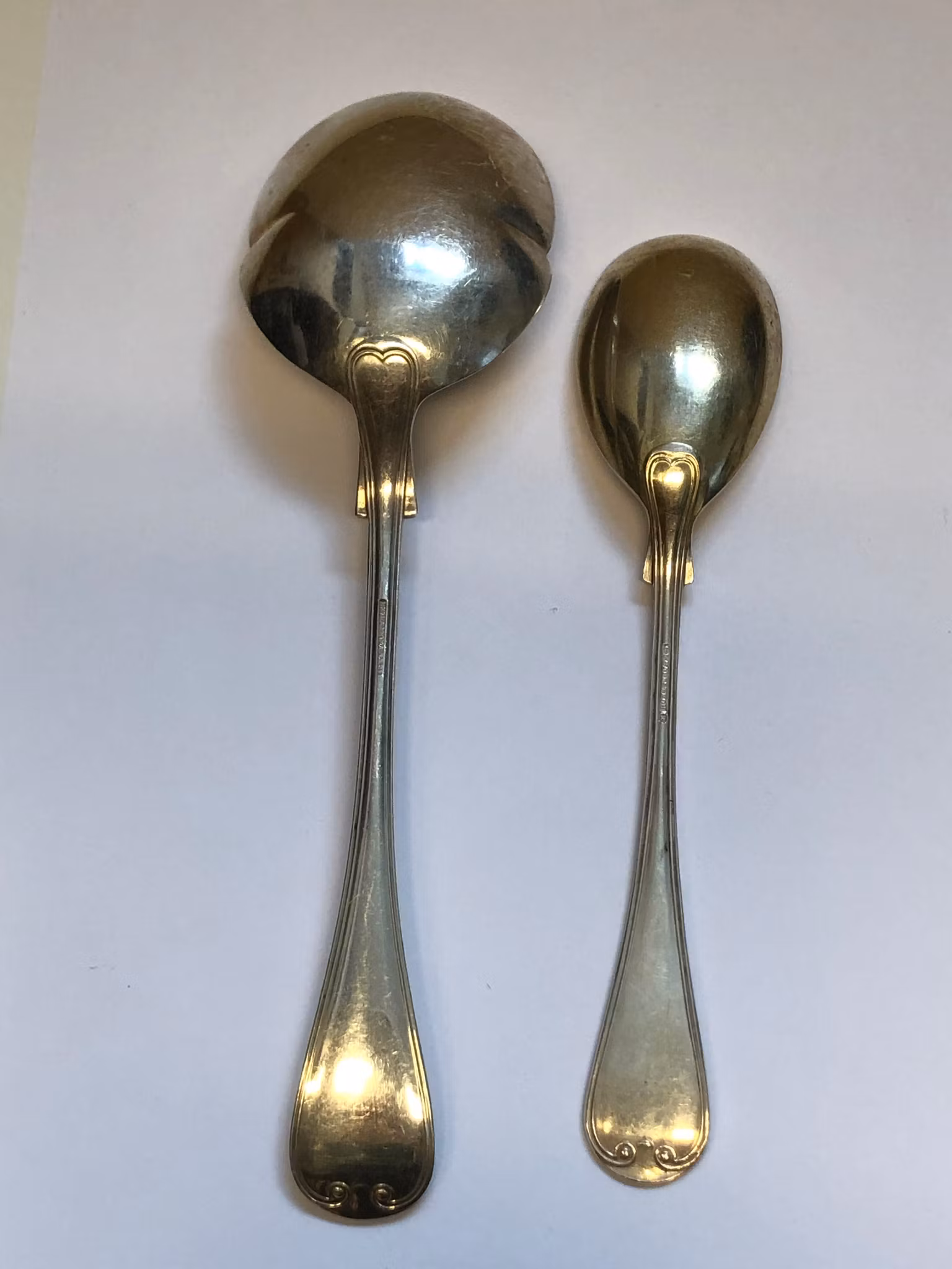 UPPLÄGGNINGSSKEDAR 2 st. nysilver,"Franska Liljan", 1900-tal.