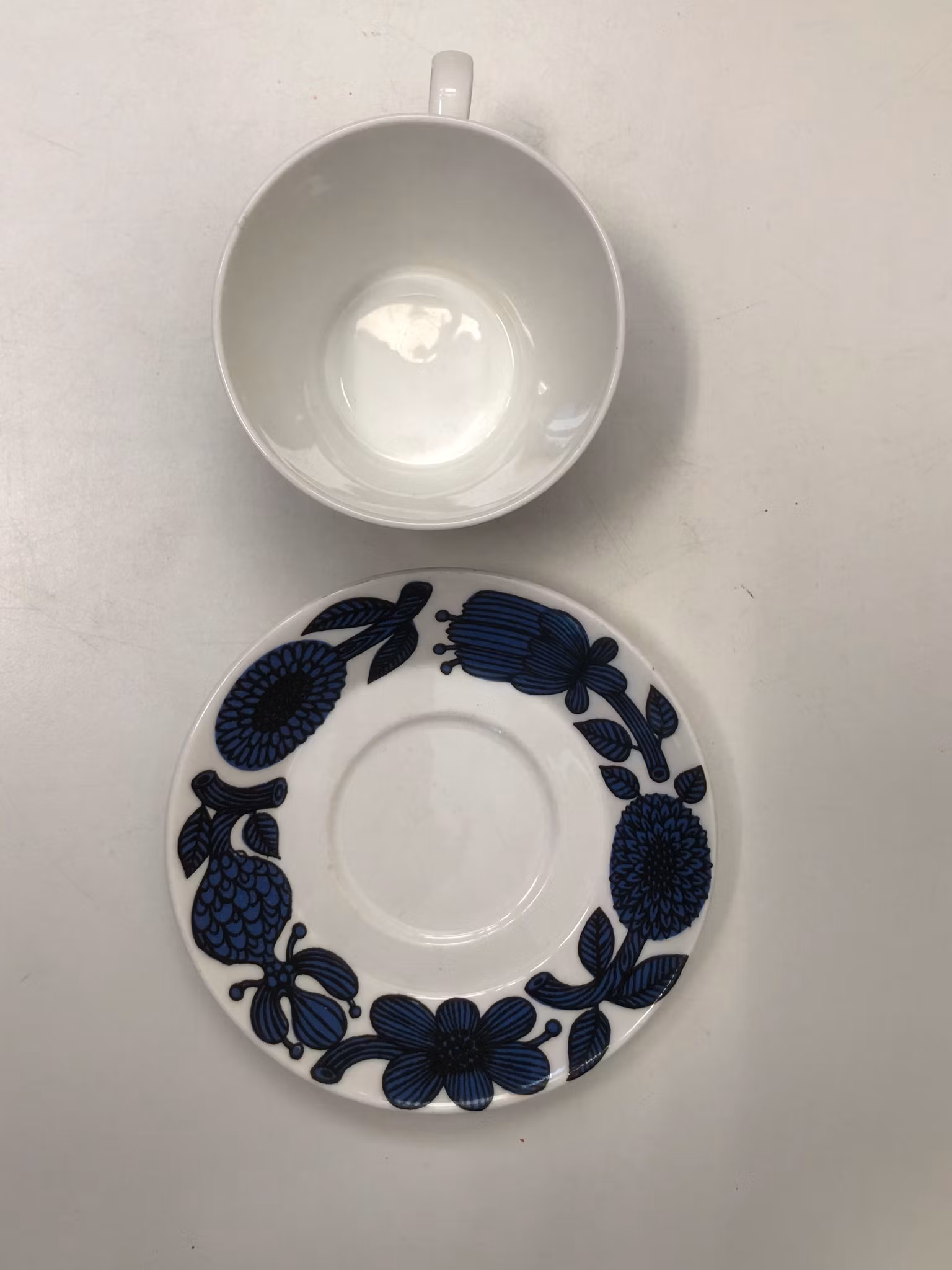 STIG LINDBERG. Kaffekopp med fat, benporslin, "Blå Aster", Gustavsberg.