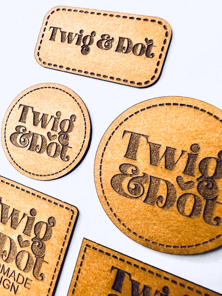 Konstläderlappar/Etiketter med streckad kant - egen logotyp