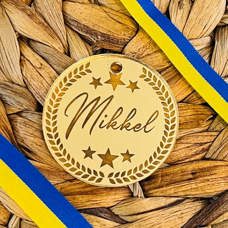 Medalj i guld med eget namn