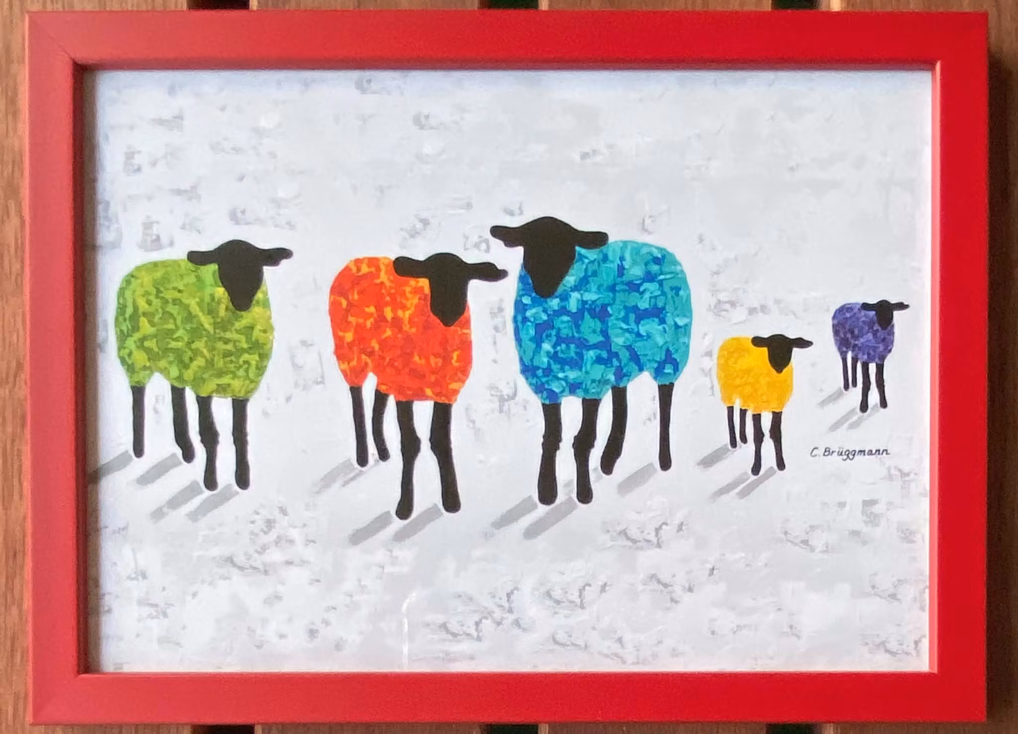 Röd ram 15x21 cm. Inramad fårkonst av C.Brüggmann från Helsingborg.
