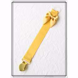 Guldfärgad napphållare med rosett - guld