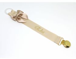Beige napphållare med rosett - guld