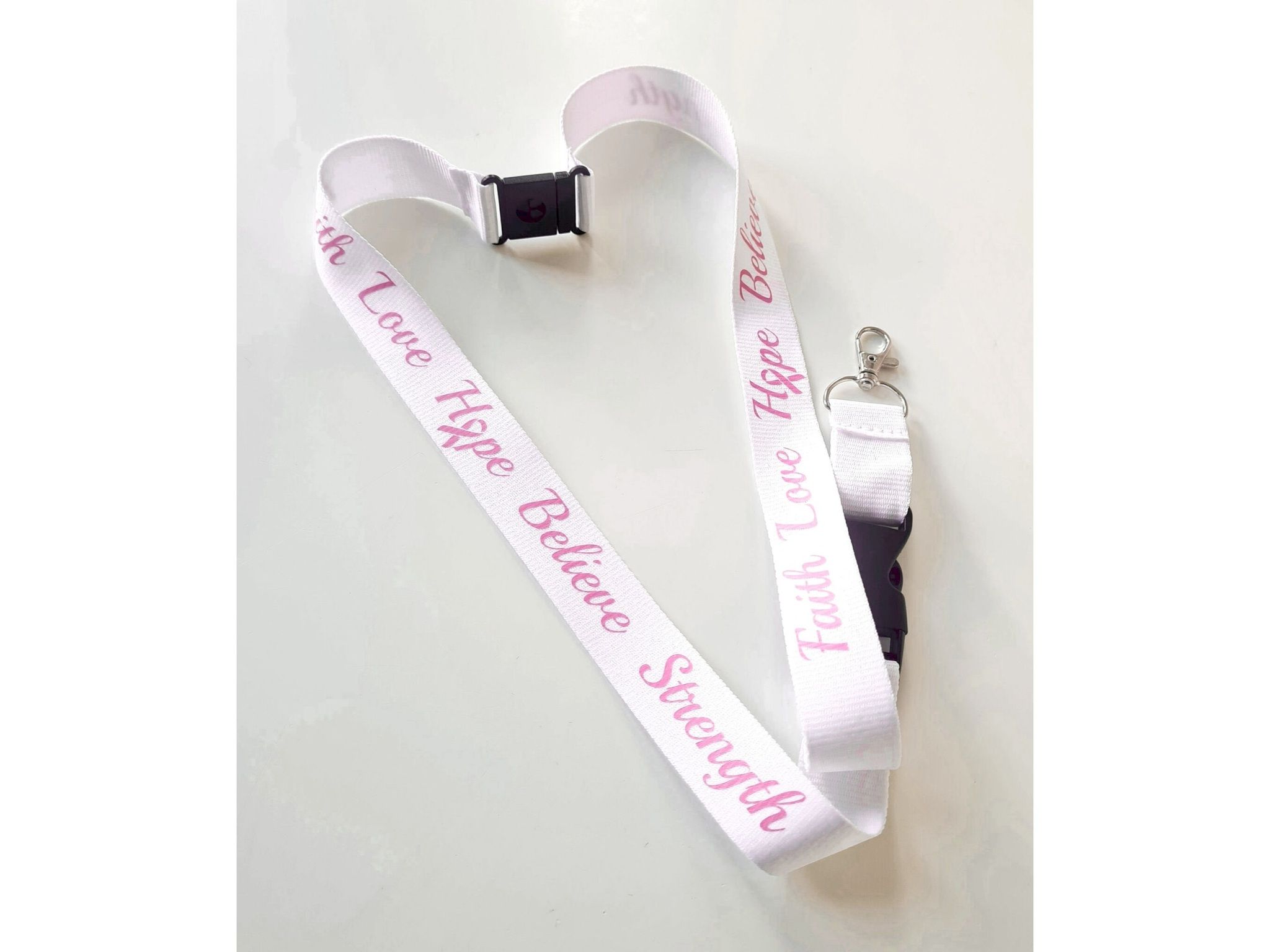 Nyckelband "Faith Love Hope Believe Strength" rosa bandet - vitt