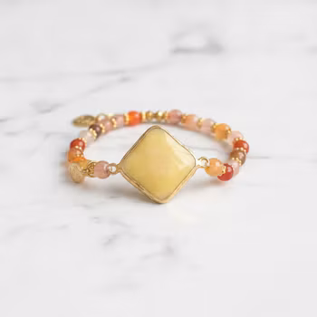 Armband orange gula stenar