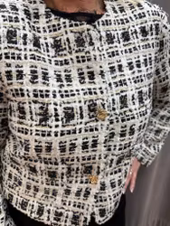 Tweedjacka i svart och vitt med guldknappar