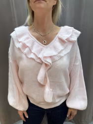 Ljusrosa stickad tröja med volang