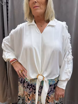 Vit blus med spets och guldspänne