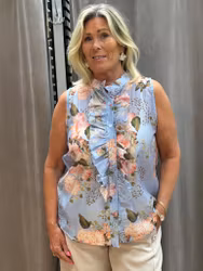 Blå armlös topp med blommönster