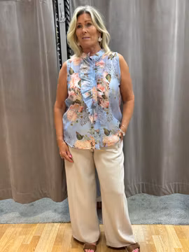 Blå armlös topp med blommönster
