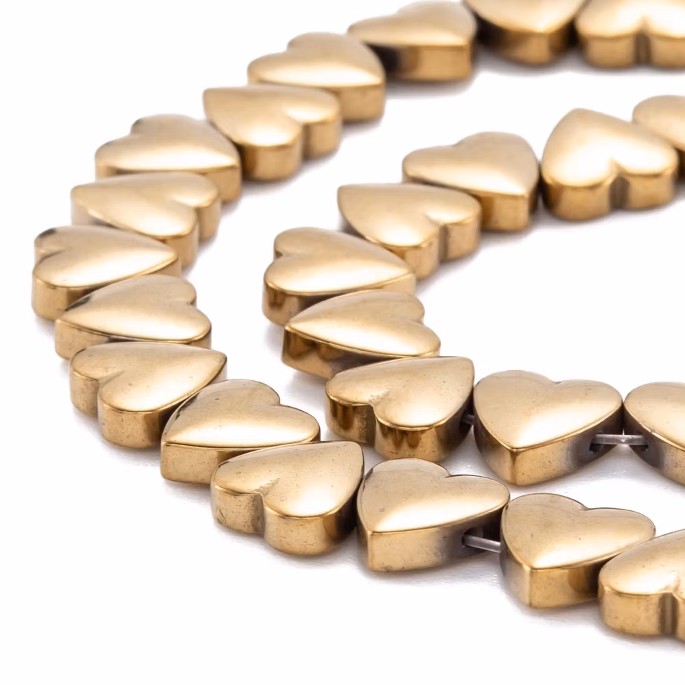 Syntetiska hematite hjärtan guldfärgade på sträng 8mm