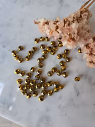 Facetterad glaspärla ca 7x5mm guldfärgad 10st