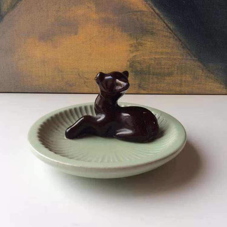 Brown deer in green ashtray 48